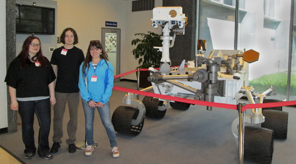 UM students Naomi Branson, left, Dirk Lawhon, and Emilyn Bauer pose with the Mars Rover on a spring break trip to NASA’s Jet Propulsion Laboratory in Pasadena, Calif.